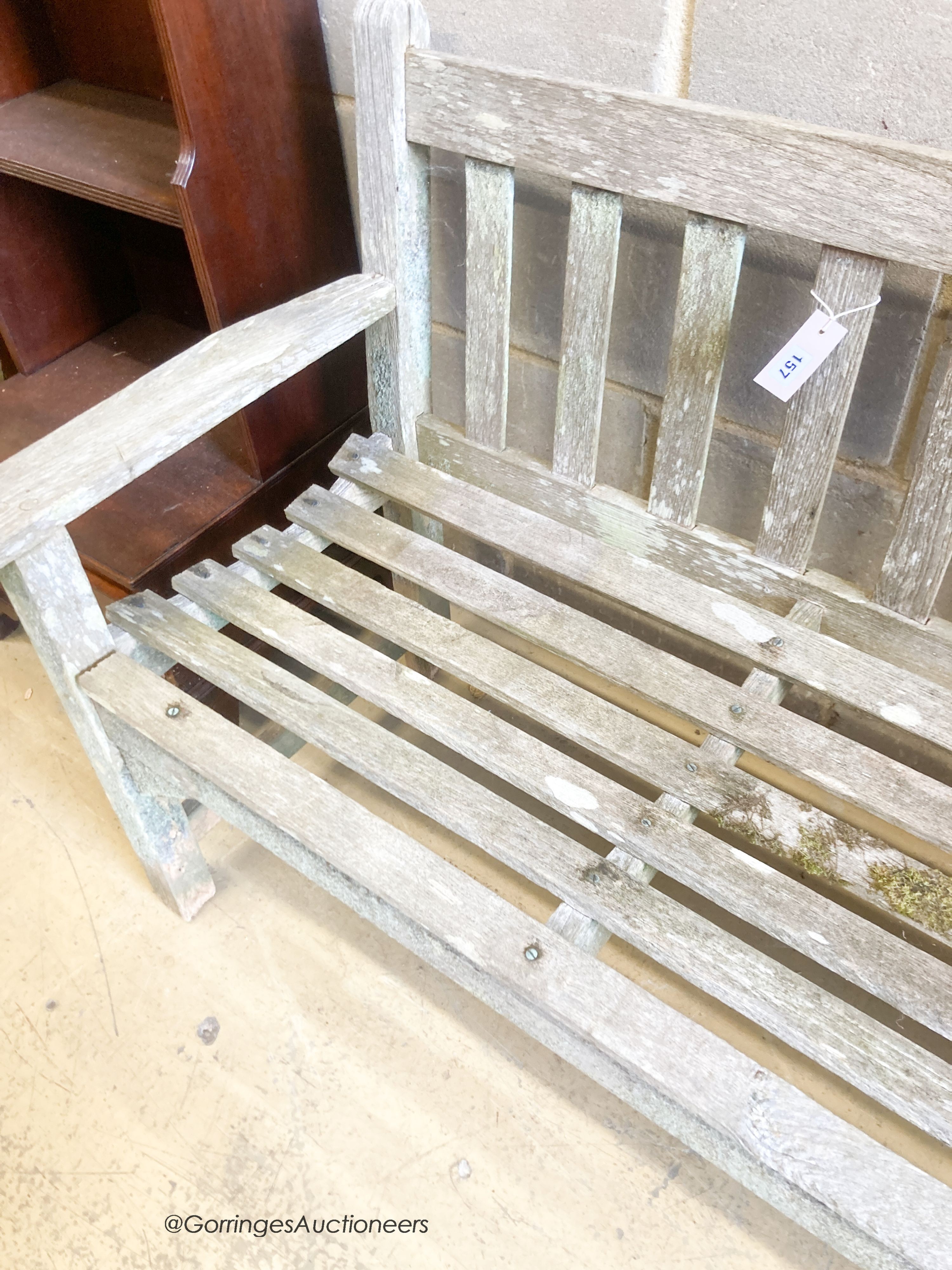 A weathered teak garden bench, length 159cm, depth 56cm, height 81cm